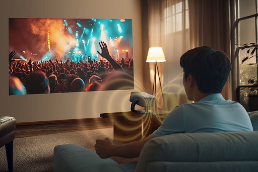 young man watching a movie on the TV in the living room, rear vi